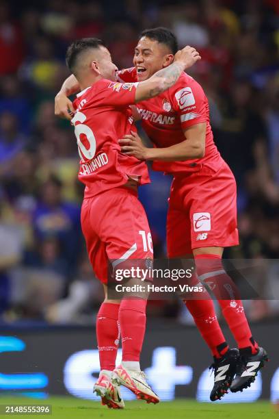 Juan Dominguez of Toluca celebrates with teammates after scoring the team's first goal during the 15th round match between America and Toluca as part...
