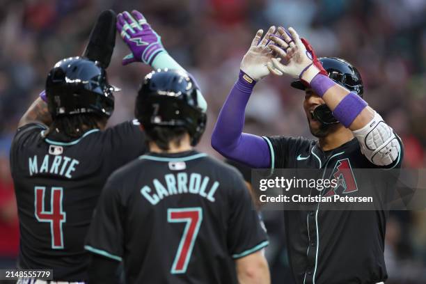 Lourdes Gurriel Jr. #12 of the Arizona Diamondbacks high fives Ketel Marte and Corbin Carroll after hitting a three-un home run against the St. Louis...