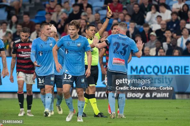 Rhyan Grant of Sydney FC receives a yellow card from referee Alireza Faghani during the A-League Men round 24 match between Sydney FC and Western...