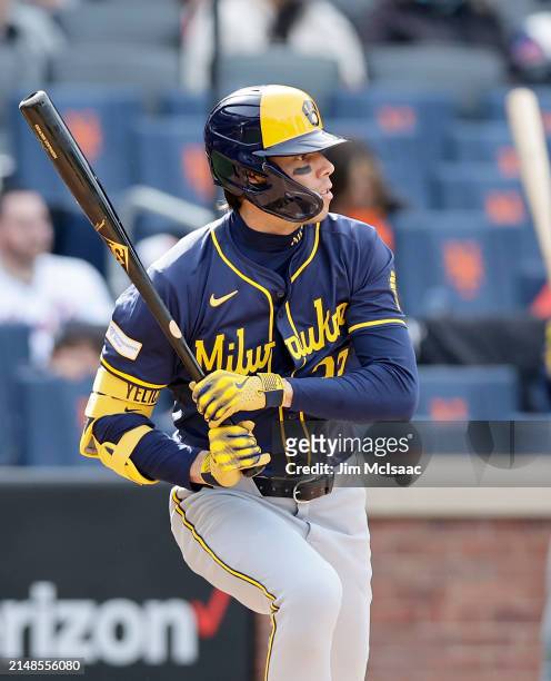 Christian Yelich of the Milwaukee Brewers follows through on an eighth inning RBI base hit against the New York Mets at Citi Field on March 30, 2024...