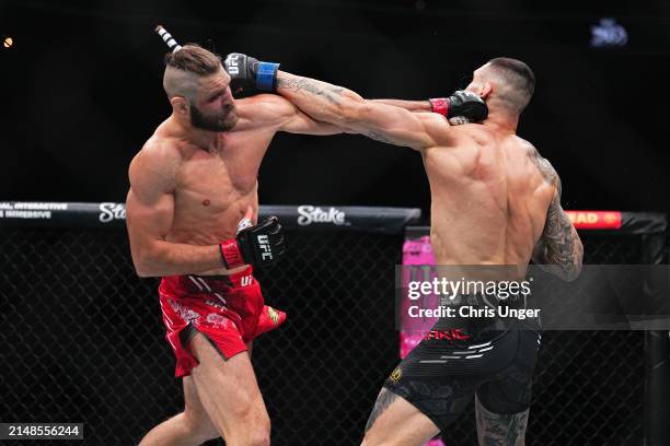 Jiri Prochazka of the Czech Republic trades punches with Aleksandar Rakic of Austria in a light heavyweight fight during the UFC 300 event at...