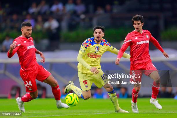 Diego Valdes of America fights for the ball with Juan Escobar and Carlos Orrantia of Toluca during the 15th round match between America and Toluca as...