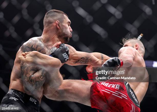 Jiri Prochazka of the Czech Republic and Aleksandar Rakic of Austria exchange strikes during their light heavyweight fight at T-Mobile Arena on April...