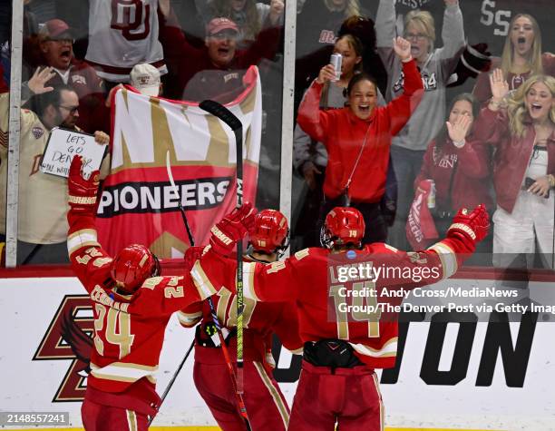 Denver Pioneers forward Kieran Cebrian , Jared Wright , center, and Denver Pioneers forward Rieger Lorenz celebrate Jared Wrights goal against the...