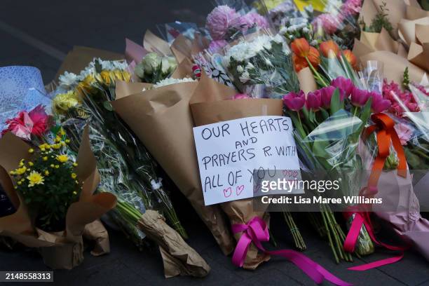 Flower tributes are seen at Oxford Street Mall alongside Westfield Bondi Junction on April 14, 2024 in Bondi Junction, Australia. Six victims, plus...
