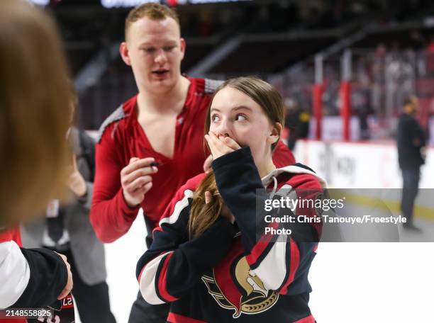 Brady Tkachuk of the Ottawa Senators signs a fans jersey following a 5-4 shootout win against the Montreal Canadiens at Canadian Tire Centre on April...