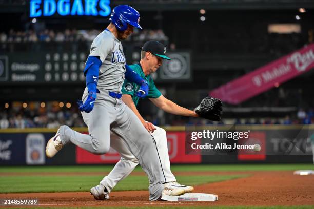 Emerson Hancock of the Seattle Mariners misplays the ball and Cody Bellinger of the Chicago Cubs is safe at first base during the sixth inning at...