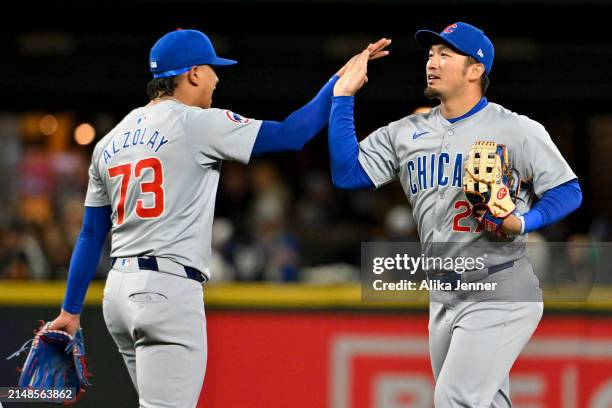 Adbert Alzolay of the Chicago Cubs and Seiya Suzuki high-five after the game against the Seattle Mariners at T-Mobile Park on April 13, 2024 in...