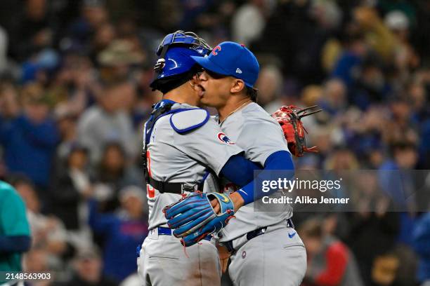 Adbert Alzolay of the Chicago Cubs and Miguel Amaya hug after the game against the Seattle Mariners at T-Mobile Park on April 13, 2024 in Seattle,...
