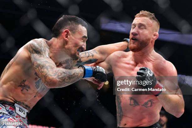 Justin Gaethje and Max Holloway exchange strikes during their BMF title fight at T-Mobile Arena on April 13, 2024 in Las Vegas, Nevada.