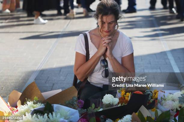 Members of the public lay floral tributes at Oxford Street Mall alongside Westfield Bondi Junction on April 14, 2024 in Bondi Junction, Australia....
