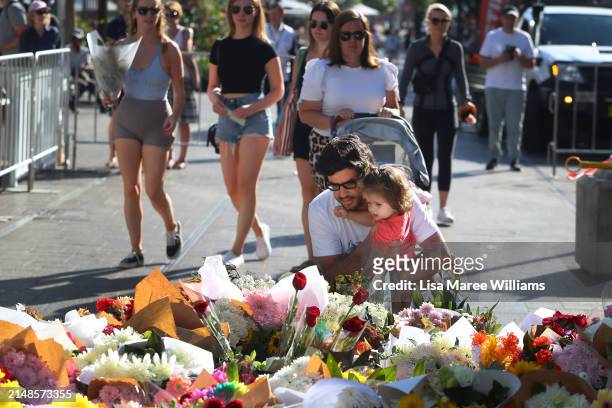 Members of the public lay floral tributes at Oxford Street Mall alongside Westfield Bondi Junction on April 14, 2024 in Bondi Junction, Australia....