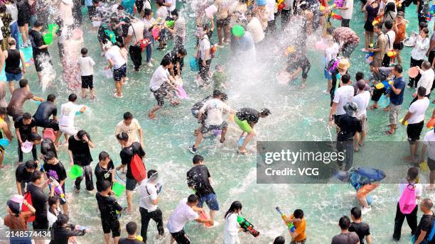 Aerial view of tourists and local people celebrating the water-splashing festival on April 13, 2024 in Yuanyang County, Honghe Hani and Yi Autonomous...