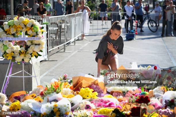 Member of the public lays a floral tribute at Oxford Street Mall alongside Westfield Bondi Junction on April 14, 2024 in Bondi Junction, Australia....