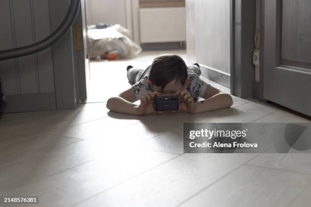 the  cute boy sitting on the floor and hugs the cat, smiling happy - neva masquerade stock pictures, royalty-free photos & images