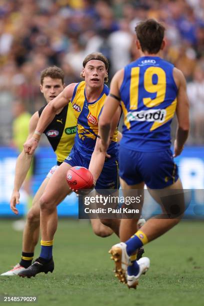 Harley Reid of the Eagles handballs to Brady Hough during the round five AFL match between West Coast Eagles and Richmond Tigers at Optus Stadium, on...