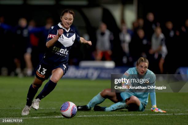 Kurea Okino of Melbourne Victory gets past Mariners' goalkeeper Casey Dumont during the A-League Women Elimination Final match between Melbourne...
