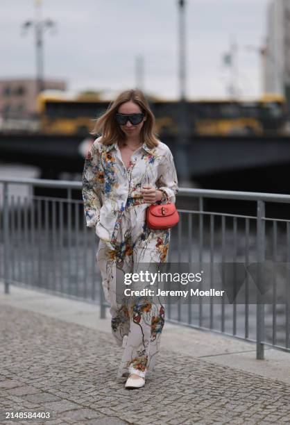 Sonia Lyson seen wearing Tom Ford black sunglasses with blue transparent lenses, Munthe white linen with colorful flower print pattern buttoned...