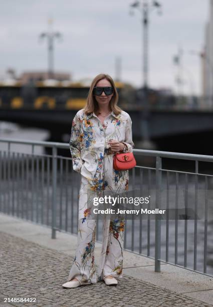 Sonia Lyson seen wearing Tom Ford black sunglasses with blue transparent lenses, Munthe white linen with colorful flower print pattern buttoned...