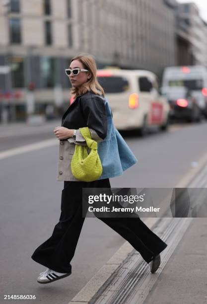 Sonia Lyson seen wearing Christian Dior white sunglasses, Munthe black leather / beige / blue denim patchwork jacket, Zara black wide leg pants,...