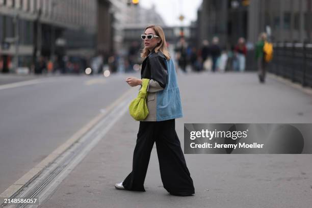 Sonia Lyson seen wearing Christian Dior white sunglasses, Munthe black leather / beige / blue denim patchwork jacket, Zara black wide leg pants,...