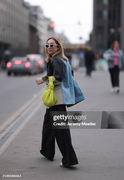 Sonia Lyson seen wearing Christian Dior white sunglasses, Munthe black leather / beige / blue denim patchwork jacket, Zara black wide leg pants,...