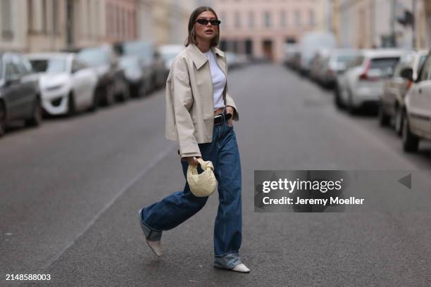 Sophia Geiss seen wearing Saint Lauren black sunglasses, Uniqlo white cotton basic top, Calvin Klein blue denim baggy jeans pants, black leather...