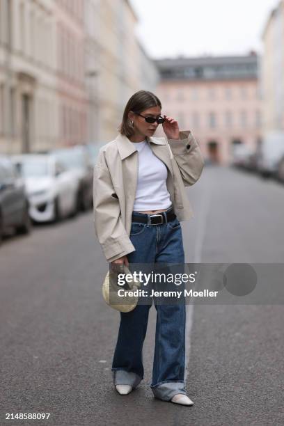 Sophia Geiss seen wearing Saint Lauren black sunglasses, Uniqlo white cotton basic top, Calvin Klein blue denim baggy wide leg jeans pants, black...