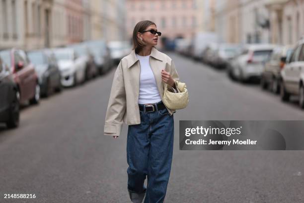 Sophia Geiss seen wearing Saint Lauren black sunglasses, Uniqlo white cotton basic top, Calvin Klein blue denim baggy wide leg jeans pants, black...