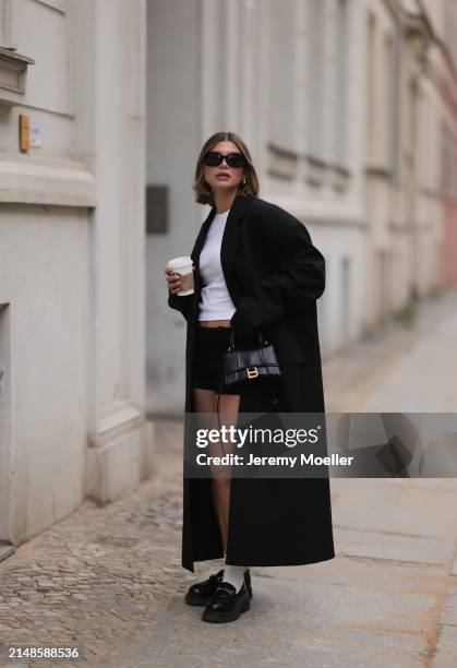 Sophia Geiss seen wearing Mango black sunglasses, Uniqlo white cotton basic top, Mango mini / micro shorts, 032c black long blazer coat, Balenciaga...