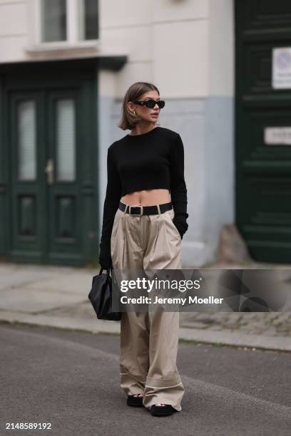 Sophia Geiss seen wearing Prada black Symbole sunglasses, silver earrings, The Frankie Shop black cotton long sleeves cropped top, Mango beige...