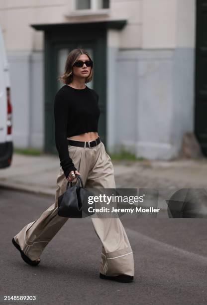 Sophia Geiss seen wearing Prada black Symbole sunglasses, silver earrings, The Frankie Shop black cotton long sleeves cropped top, Mango beige...