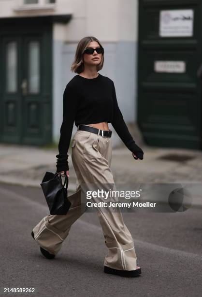 Sophia Geiss seen wearing Prada black Symbole sunglasses, silver earrings, The Frankie Shop black cotton long sleeves cropped top, Mango beige...