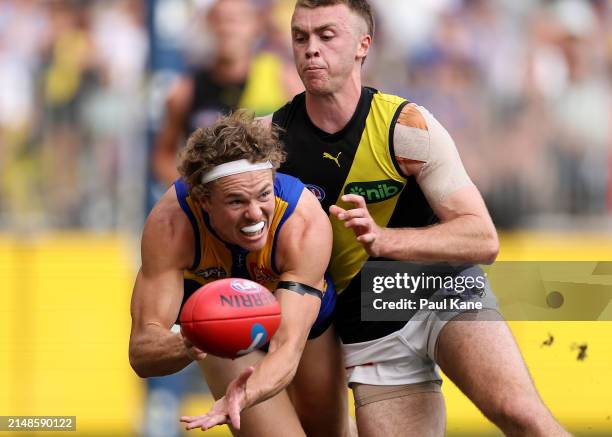 Jayden Hunt of the Eagles handballs during the round five AFL match between West Coast Eagles and Richmond Tigers at Optus Stadium, on April 14 in...