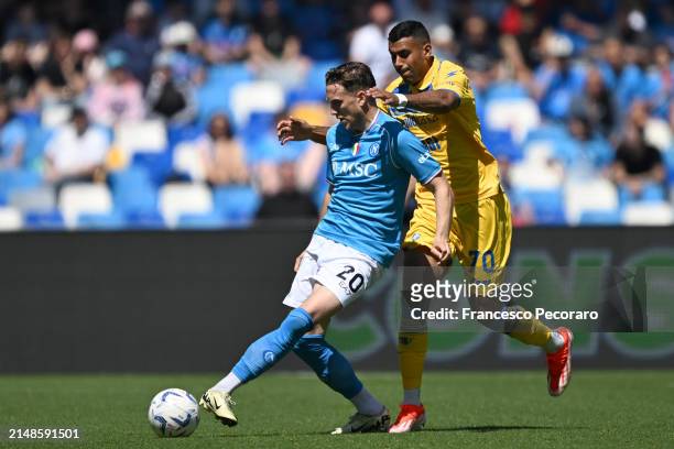 Piotr Zielinski of SSC Napoli battles for possession with Walid Cheddira of Frosinone Calcio during the Serie A TIM match between SSC Napoli and...
