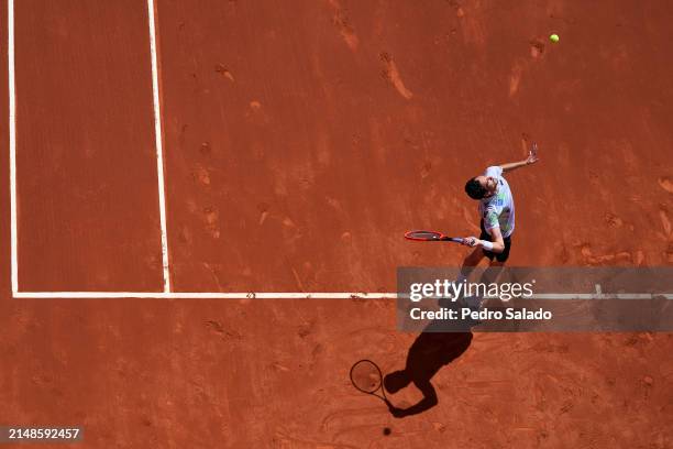 Gianluca Mager of Italy on serve against Marco Trungelliti of Argentina during qualifying round of Barcelona Open Banc Sabadell 2024 at Real Club De...