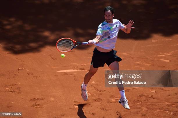 Gianluca Mager of Italy plays a forehand against Marco Trungelliti of Argentina during qualifying round of Barcelona Open Banc Sabadell 2024 at Real...