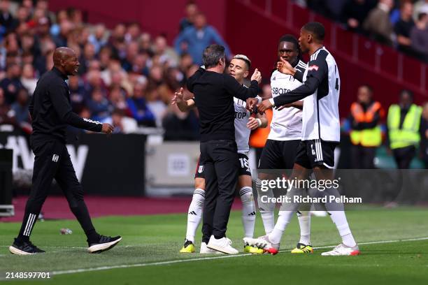 Andreas Pereira of Fulham celebrates scoring his team’s first goal with Marco Silva, Manager of Fulham, and teammates during the Premier League match...