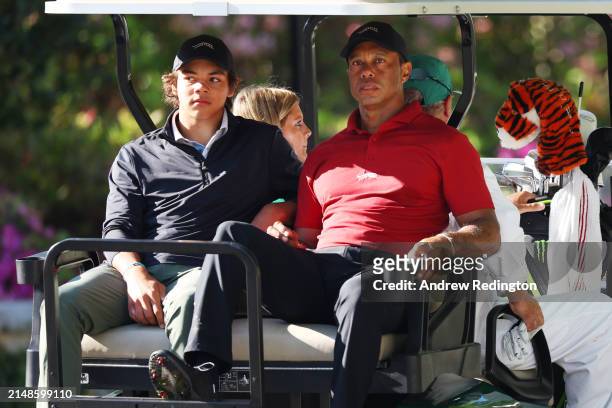 Tiger Woods of the United States and his son Charlie Woods depart the practice area in a cart during the final round of the 2024 Masters Tournament...