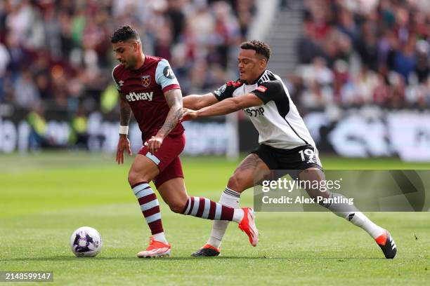 Emerson Palmieri of West Ham United is challenged by Rodrigo Muniz of Fulham during the Premier League match between West Ham United and Fulham FC at...