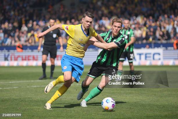 Johann Thorir Helgason of Braunschweig and Marcel Halstenberg of Hannover compete for the ball during the Second Bundesliga match between Eintracht...