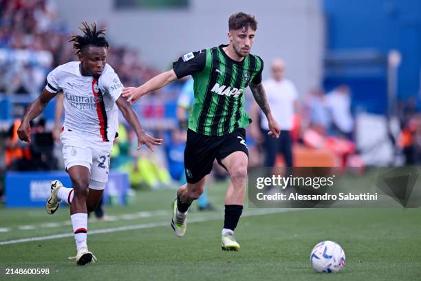 Mattia Viti of US Sassuolo runs with the ball whilst under pressure from Samuel Chukwueze of AC Milan during the Serie A TIM match between US...