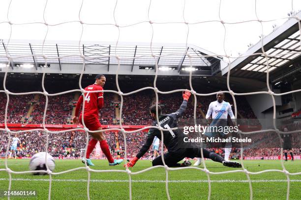 Eberechi Eze of Crystal Palace scores his team's first goal past Virgil van Dijk and Alisson Becker of Liverpool during the Premier League match...
