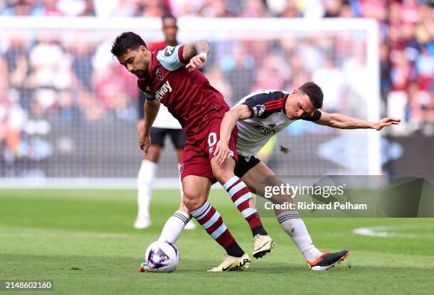 Lucas Paqueta of West Ham United is challenged by Joao Palhinha of Fulham during the Premier League match between West Ham United and Fulham FC at...