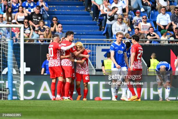 Ritsu Doan of SC Freiburg celebrates scoring his team's first goal with teammates during the Bundesliga match between SV Darmstadt 98 and Sport-Club...
