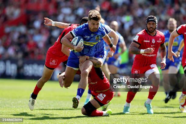 Henry Slade of Exeter Chiefs is tackled by Romain Ntamack of Stade Toulousain during the Investec Champions Cup Quarter Final match between Stade...