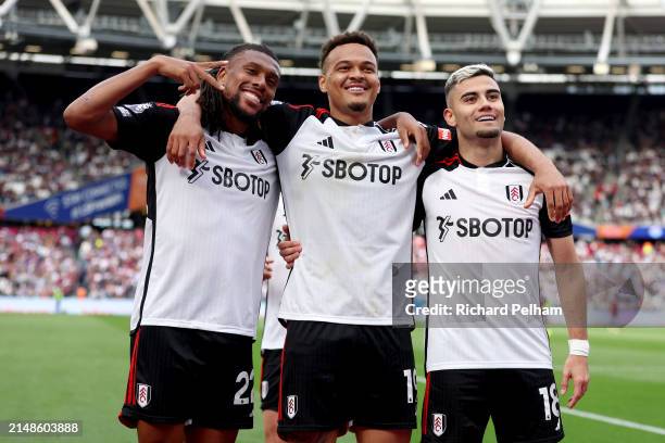 Andreas Pereira celebrates scoring his team's second goal with Alex Iwobi and Rodrigo Muniz of Fulham during the Premier League match between West...