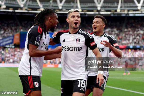 Andreas Pereira of Fulham celebrates scoring his team's second goal with Alex Iwobi and Rodrigo Muniz of Fulham during the Premier League match...