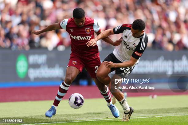 Ben Johnson of West Ham United is challenged by Antonee Robinson of Fulham during the Premier League match between West Ham United and Fulham FC at...