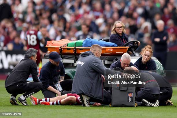George Earthy of West Ham United receives medical treatment before being stretchered off after picking up an injury during the Premier League match...